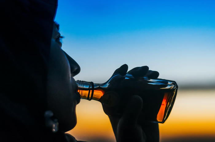 man-drinking-small-bottle-spirit