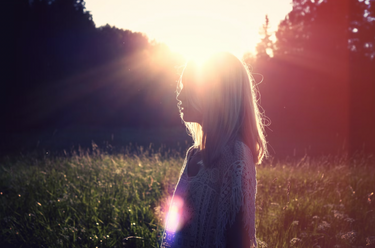Women-in-green-field-with-sun-flair