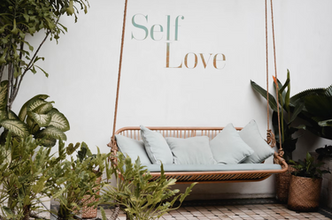 brown-rattan-swing-bench-self-love-print